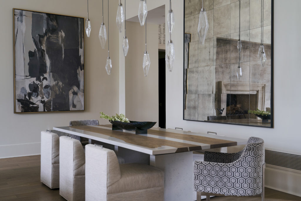 Open-concept dining room with custom marble and iron table.
