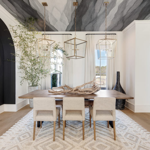 Dining area with neutral colors, wooden accents, and stunning seating.