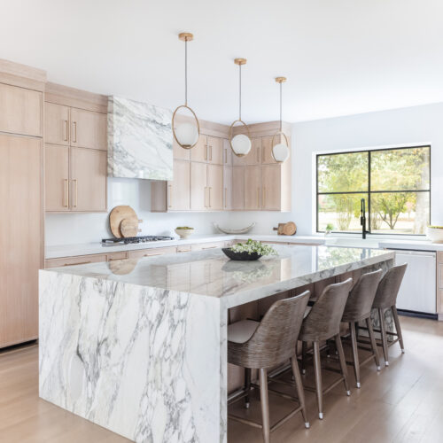 Kitchen featuring luxury cabinetry and a central marble island.
