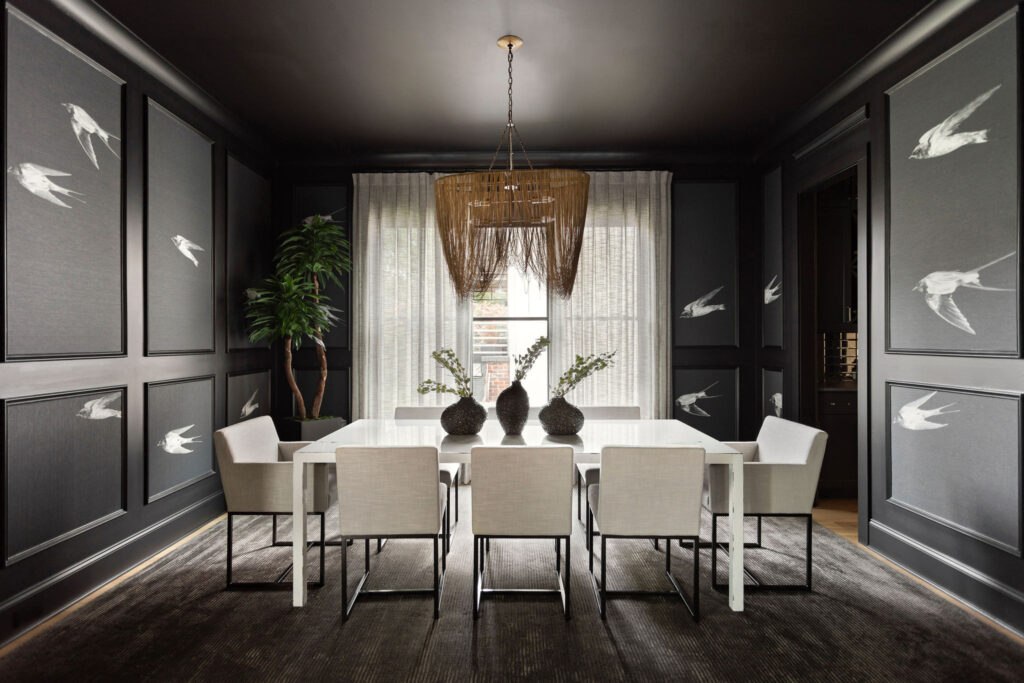 A sophisticated dining room painted in a deep, dark gray, radiating elegance.